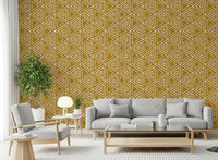 A Living room rests under earthy ochre mudcloth wallpaper dotted with triangles