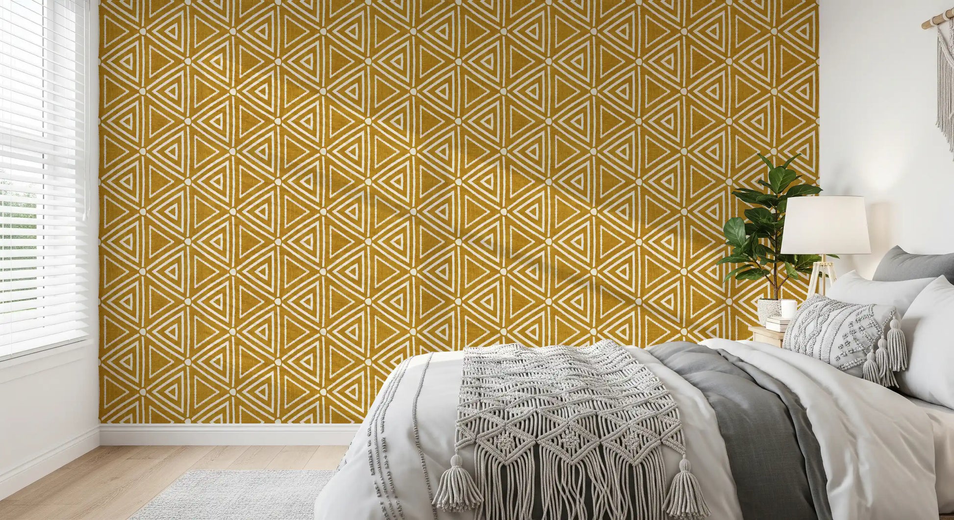 Mudcloth triangles sit in tight rows over a warm mustard wallpaper ground