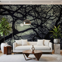 Living room gathers gothic mood from the Midnight Branches wall mural and its dark twigs.