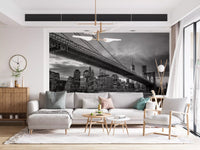 Bridge towers stand against a moody Manhattan skyline in this Iconic Brooklyn Night wall mural