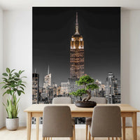 Potted plants in the dining room contrast against the tall Grayscale wall mural scenery.