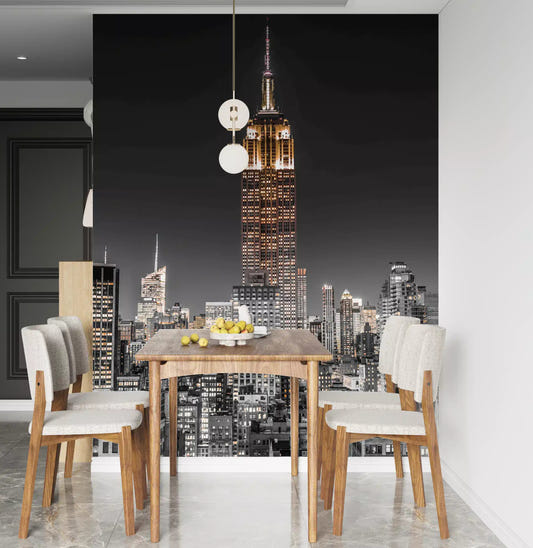 A dining room features the Empire Glow NYC Night in Grayscale Gold wall mural.
