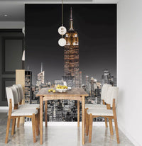 A dining room features the Empire Glow NYC Night in Grayscale Gold wall mural.