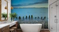 Set behind a Bathroom, mossy posts and pebbles fill this Ethereal Coastline wall mural.