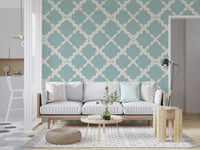 Muted blue minimalist wallpaper surrounds the perimeter of a bright open living room
