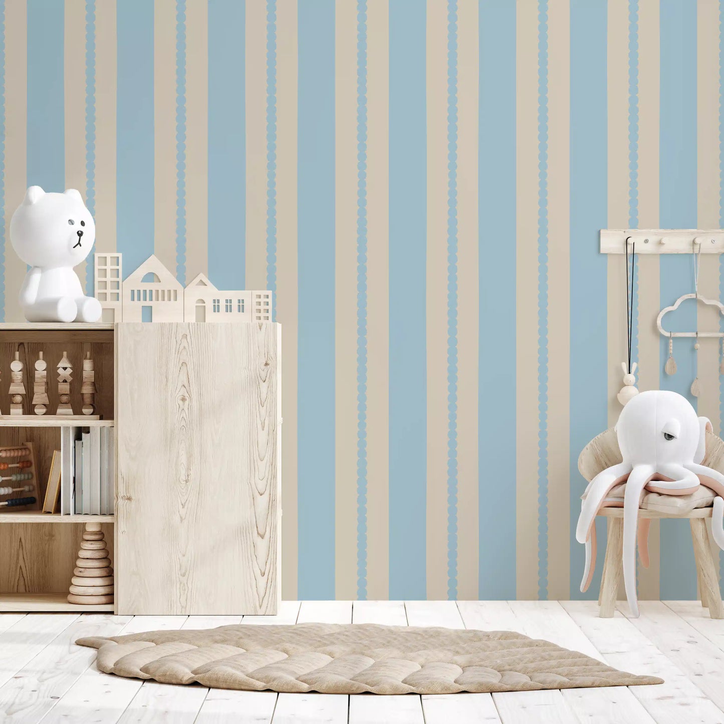 Gentle blue and beige tones of the Serenity wallpaper in a Nursery area .