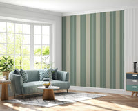 The Soft Sage and Beige Stripes Wallpaper installed in a sunny hallway.