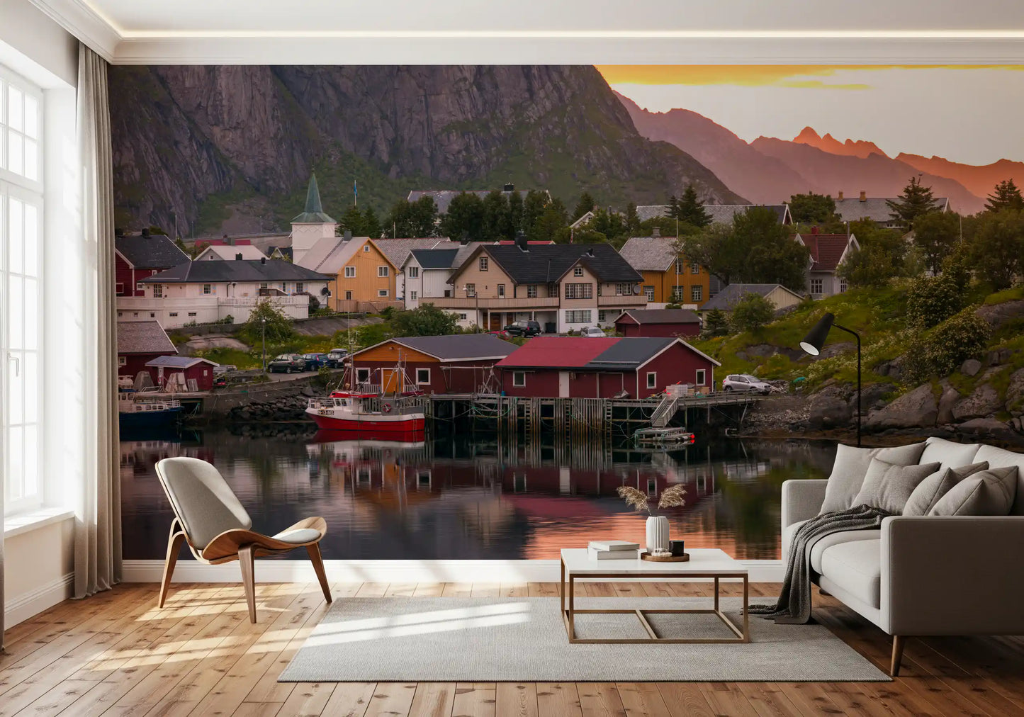 mountains from the Lofoten Village Sunset & Fjord Wall Mural fill a living room.