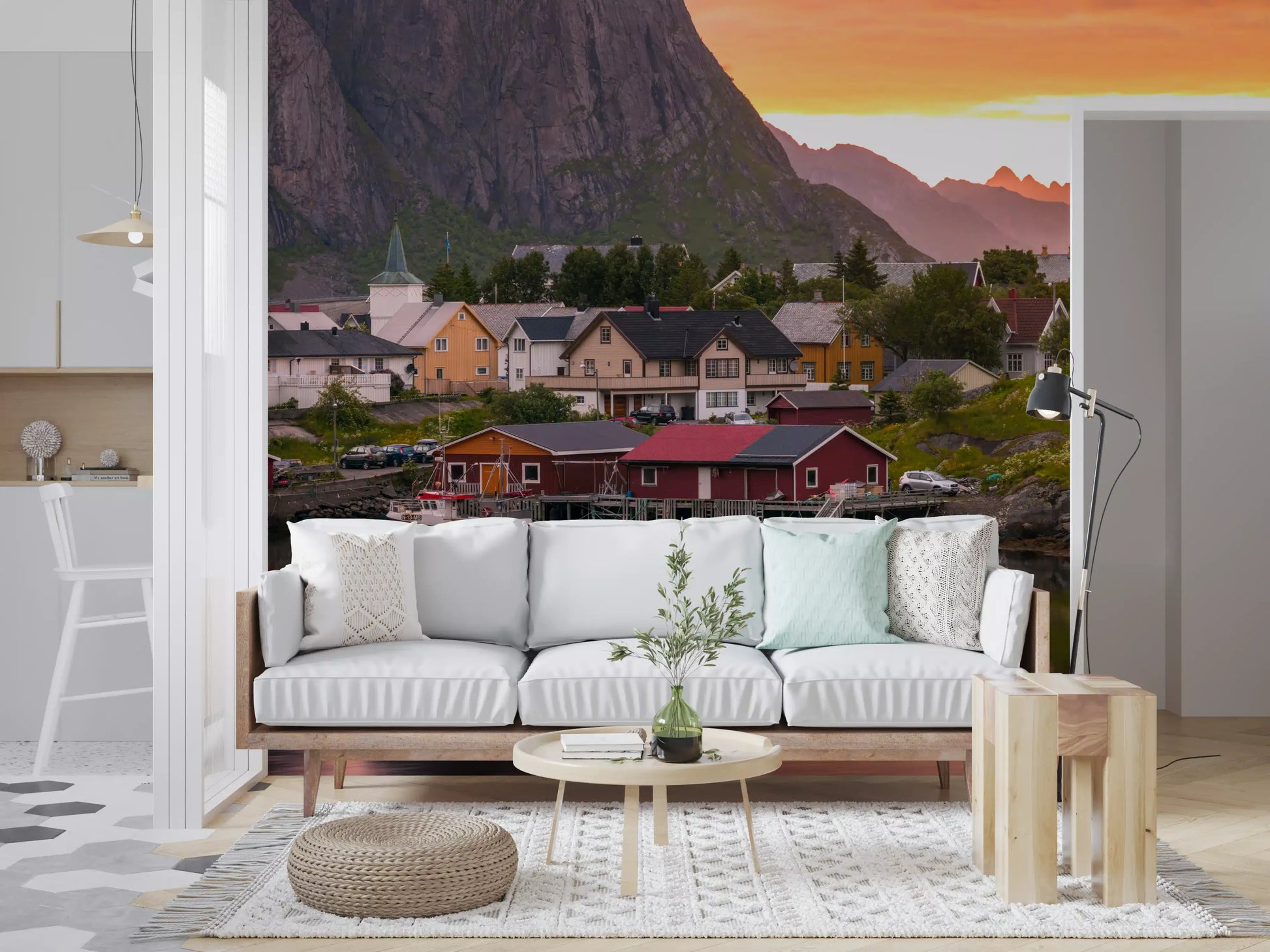 Colorful wooden cabins sit peacefully at the base of a towering Lofoten wall mural.