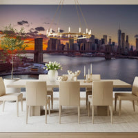 In a Dining room, the NYC Sunset Grandeur wall mural opens a deep horizon view.