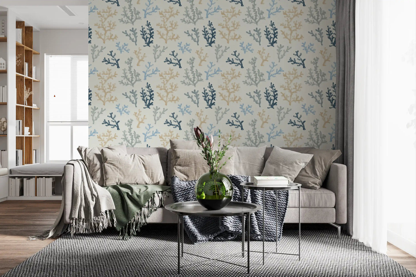 Dark bedding creates a striking contrast with the Painted Corals Wallpaper in this Living roo  .