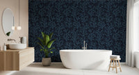 Rich teal botanical shapes stretch over a dark wallpaper canvas.