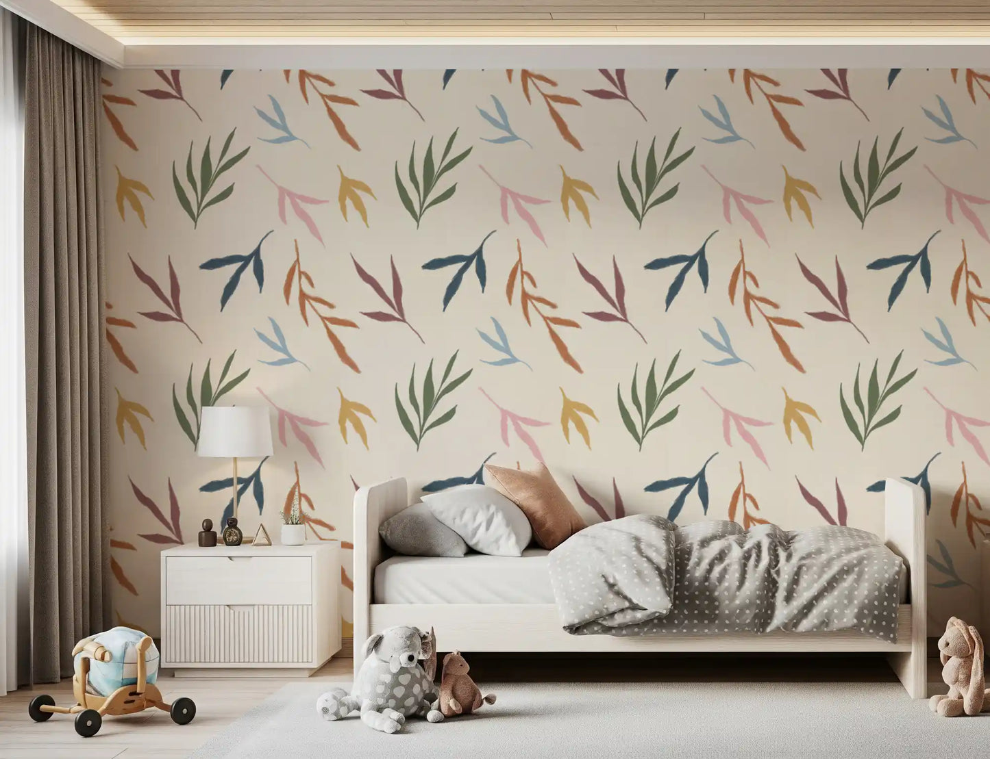 Bedroom wall showing painted leaves wallpaper on a pale textured base