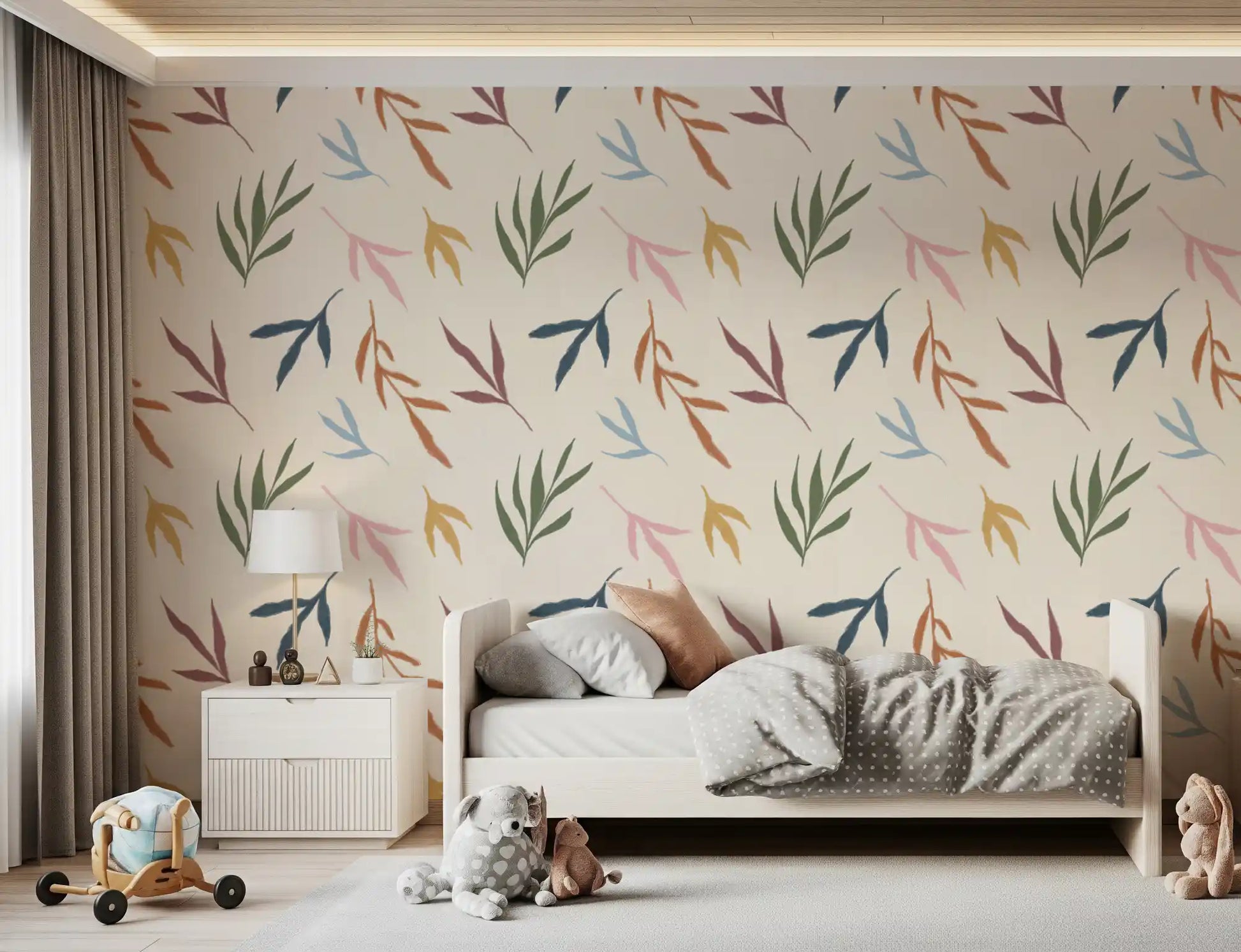Bedroom wall showing painted leaves wallpaper on a pale textured base