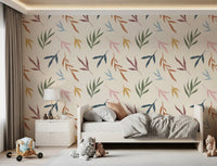 Bedroom wall showing painted leaves wallpaper on a pale textured base