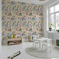 Kids room featuring Collage Wallpaper with pastel leaves and art details