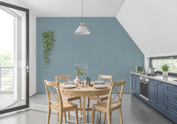 Dining room using soft blue wallpaper with a calm mid century finish