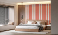 Bedroom wall styled in Coastal Stripe Wallpaper with coral detailing