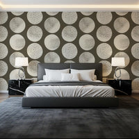 Cream polka dot wallpaper with large stippled circles on a dark base