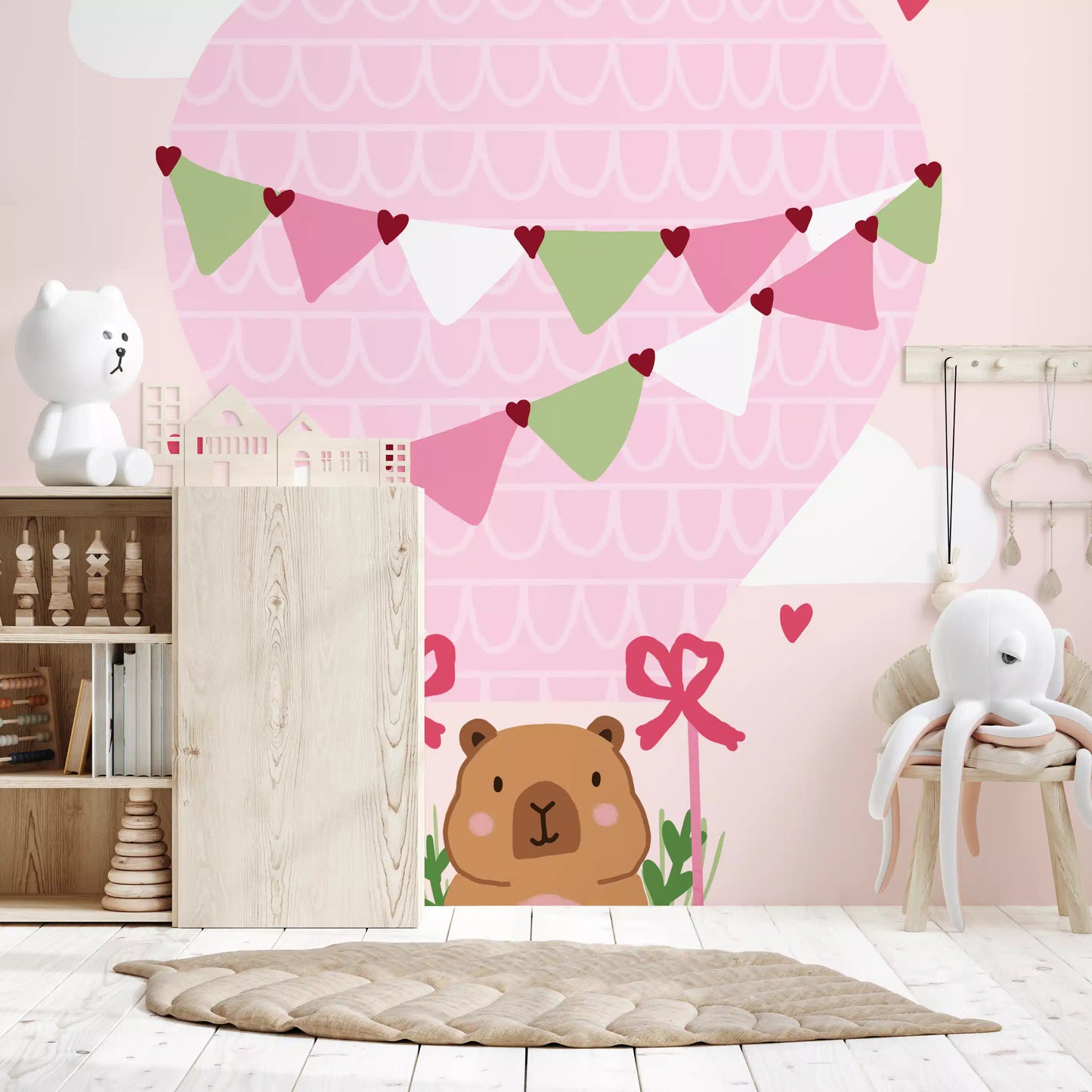 Pink nursery wall mural with teddy bear basket and gentle heart motifs
