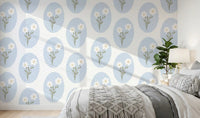 Pale blue ovals and tiny white blooms behind a bedroom headboard wallpaper