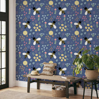 Living room corner styled with the bee wallpaper above a low bed
