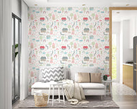 Pastel cottages and rainbows of the Baby Village wallpaper line a cosy living room