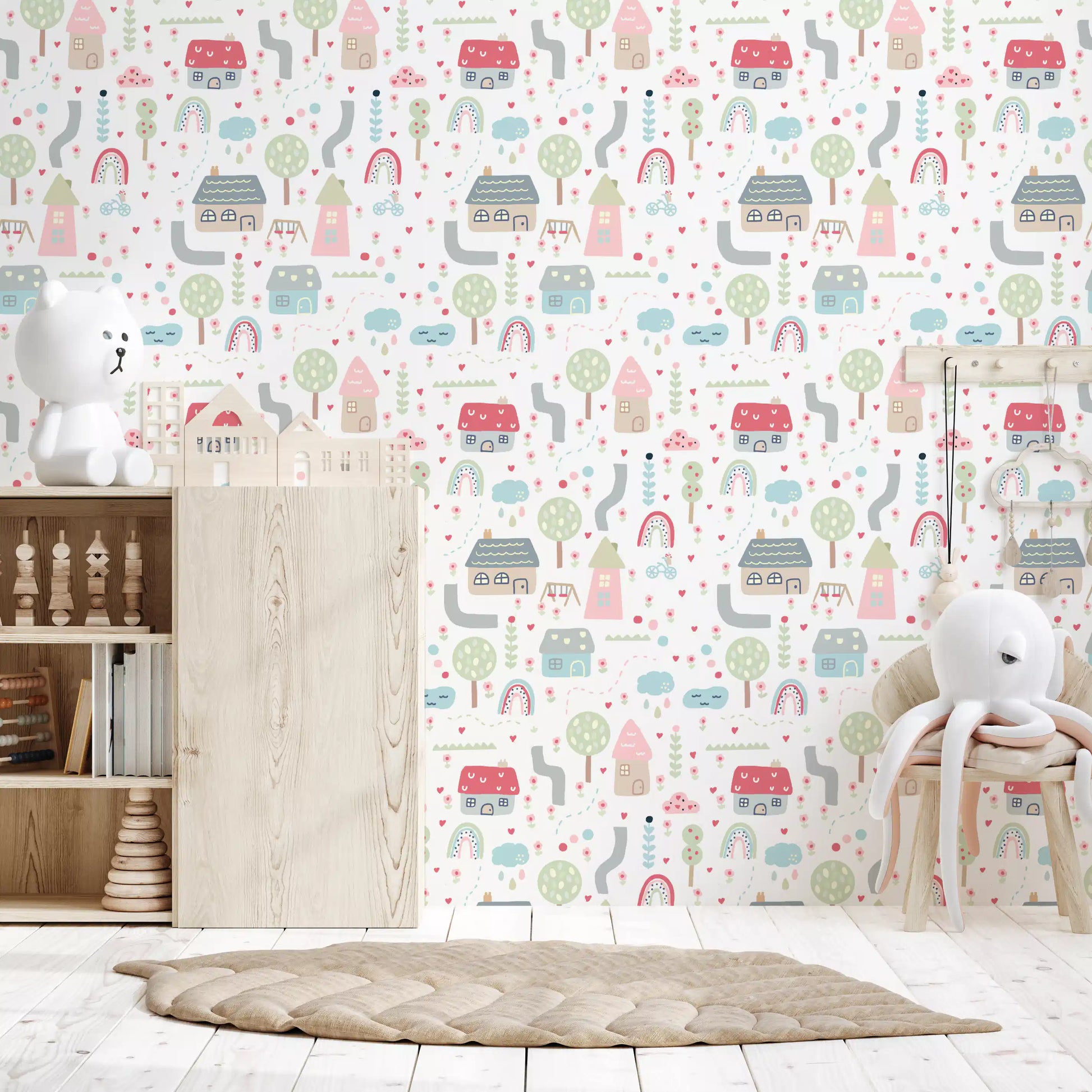 Nursery cot framed by the Baby Village wallpaper in pastel pink and sage tones