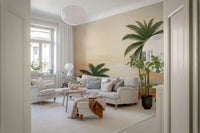 Peach skies and green palms warm a lounge under Lush Retreat wall mural.