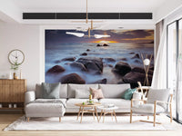 Warm shoreline glow fills this lounge through the Coastal Splendor wall mural
