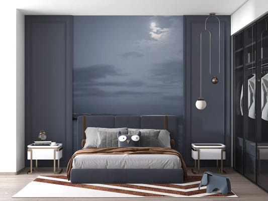 Moonlit Ocean Serenity wall mural set behind a bed in a deep blue bedroom