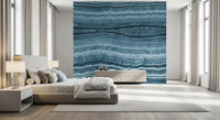 Bedroom finished in a blue marble wall mural with horizontal mineral veining