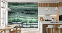 Kitchen and dining area corner finished with the green marble wall mural beside soft drapes.