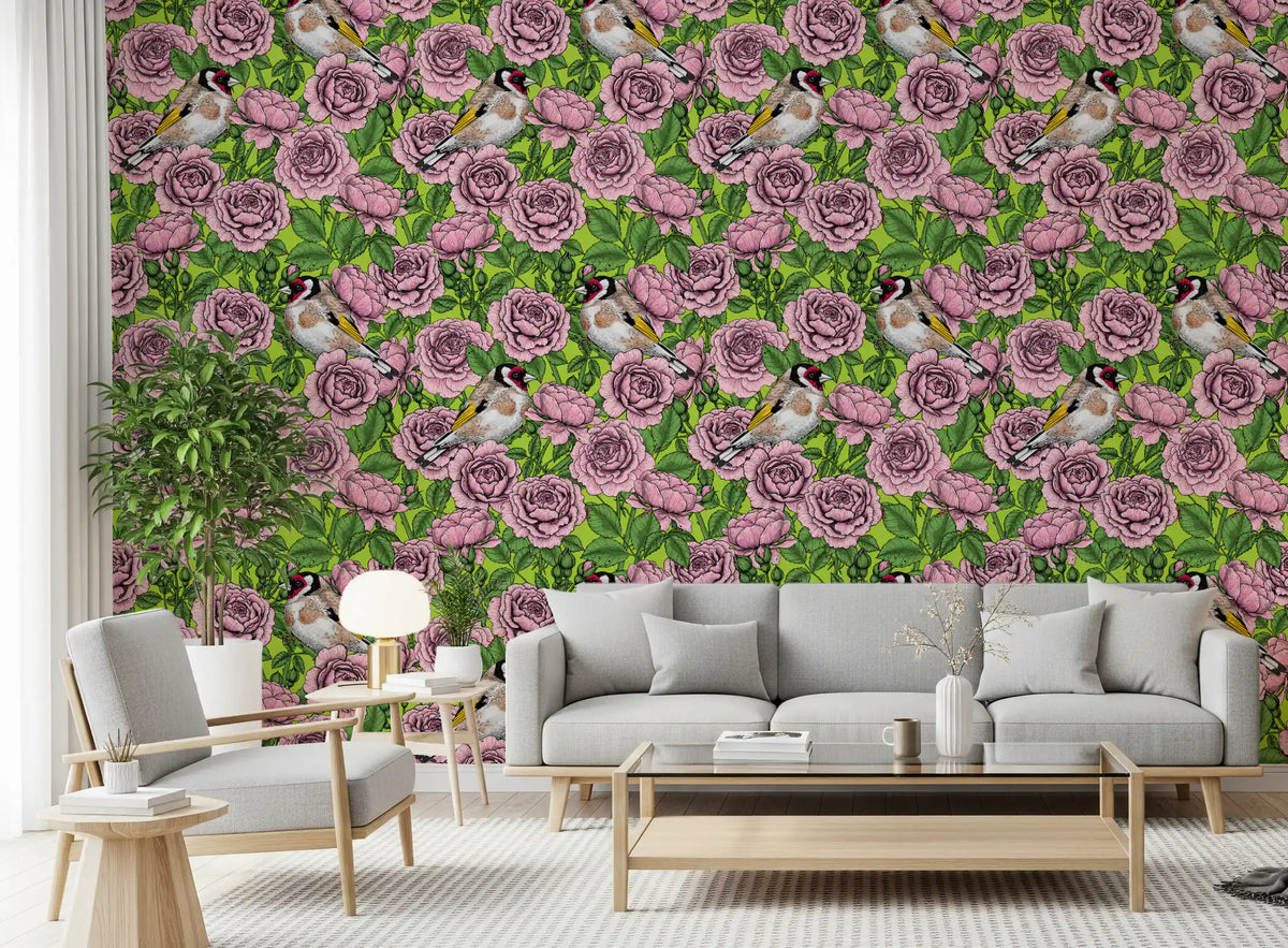 Pink roses and finches fill the Goldfinch Rose Garden wallpaper in a living room.