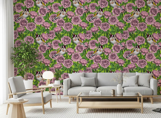 Pink roses and finches fill the Goldfinch Rose Garden wallpaper in a living room.