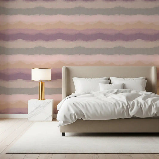 Mauve and peach horizons fill a bedroom in the Sunrise Painted Horizon wallpaper.