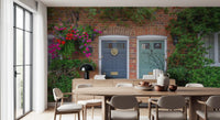 Brick building wall mural featuring flower filled entrances