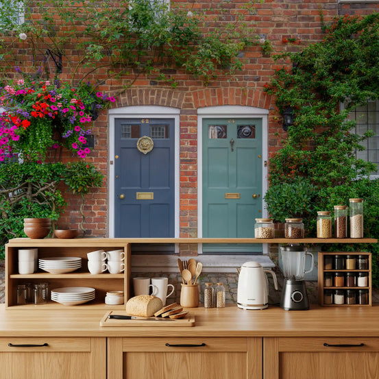 Cottage style wall mural with flowers around brick doorways
