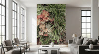 Botanical wall mural with overlapping leaves and gentle colours