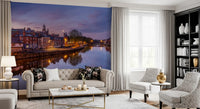 Riverside city wall mural with colourful dusk sky reflections