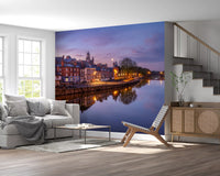 European riverside wall mural with warm lights on the water