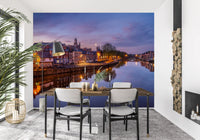 Historic riverside wall mural featuring glowing evening scenery