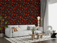 In a low-lit lounge, the Pomegranate Nocturne wallpaper plays out fruit and moth detail.