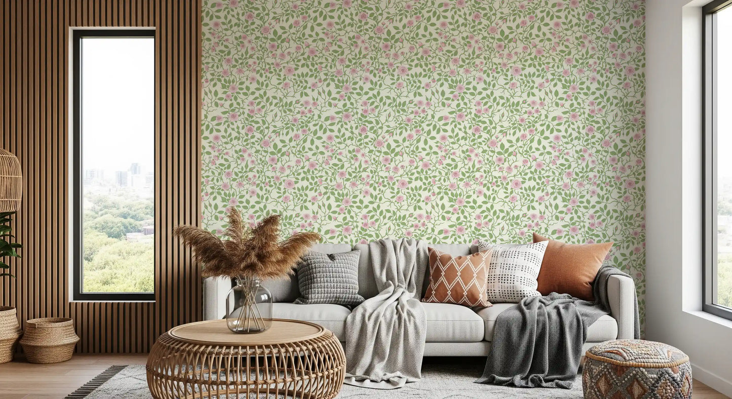 Cream ground holds pale roses, green leaves, and thorny stems in this briar wallpaper.
