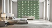 Vertical drop motifs in cream travel down a sage green Mid Century Seed Dots wall mural.