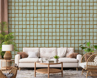Mid Century Wavy Grid Soft Sage wallpaper warms a relaxed living room.