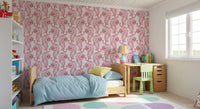 Pale pink stays gentle behind every crimson tiger on this chinoiserie wallpaper.