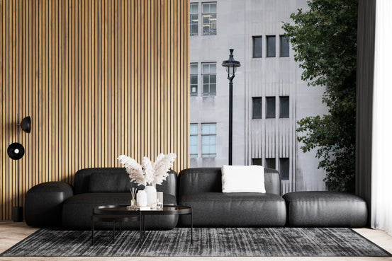 Wall mural with a pale city facade rising over a living room, GD11209