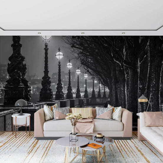 Rainy lamplit promenade glows behind a living room wall mural GD11416