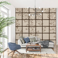 Shoji screen grid and ginkgo leaves on a wall mural across a living room GD11495